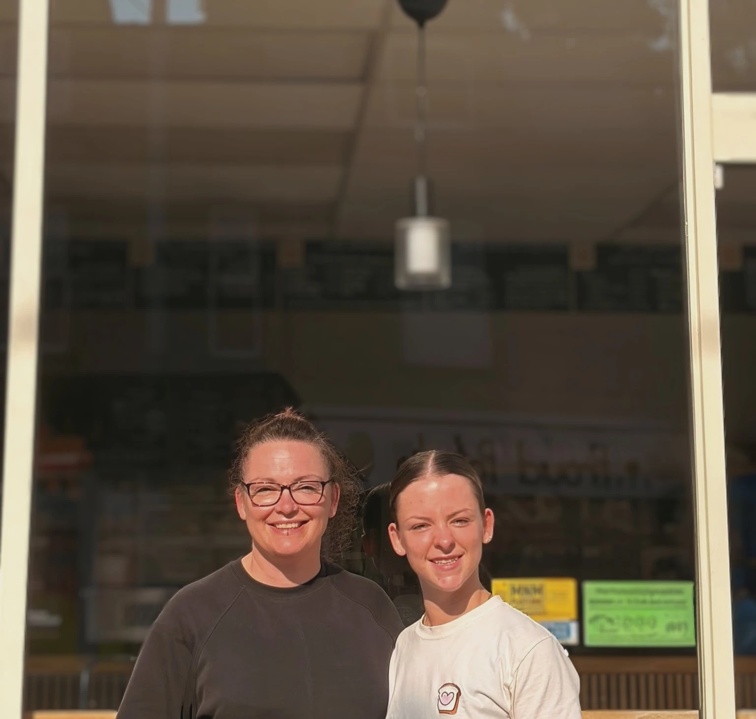 Hannah and Adele in front of the shop